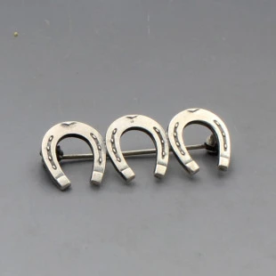 NE From Silver Triple Horseshoe Brooch