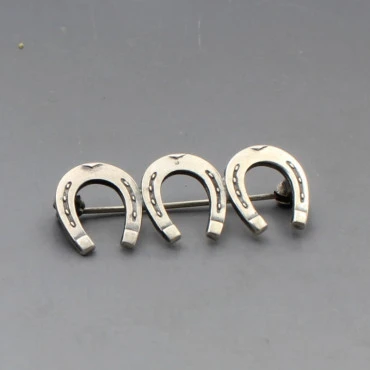 NE From Silver Triple Horseshoe Brooch